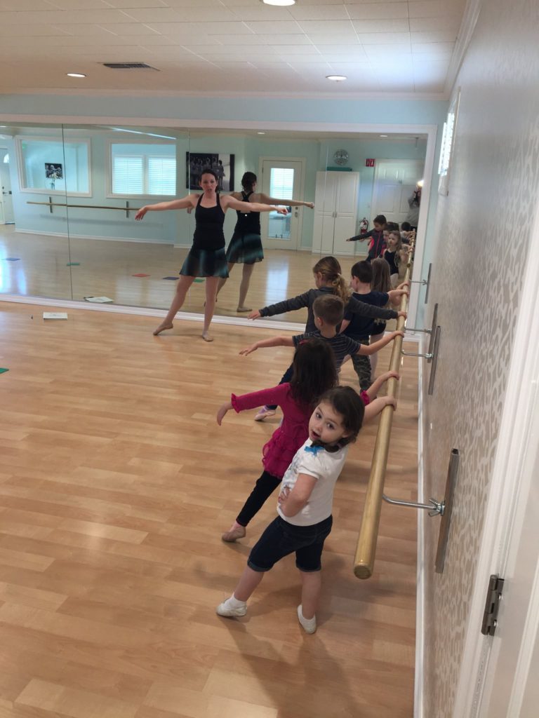 Children in the middle of a dance lesson